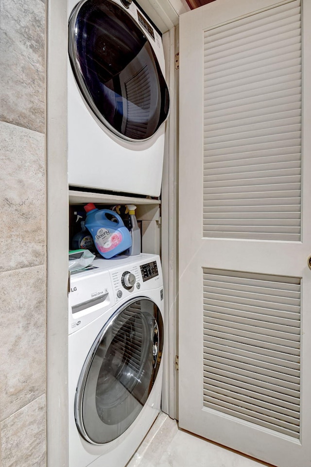 clothes washing area with stacked washer and clothes dryer