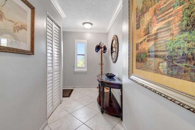 corridor featuring a textured ceiling, light tile patterned floors, and ornamental molding