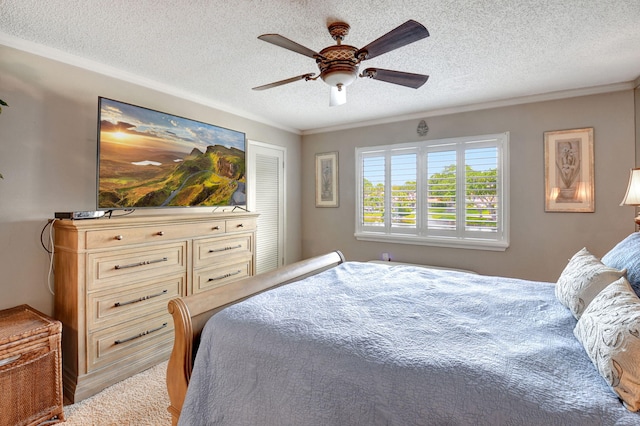 bedroom with a textured ceiling, ceiling fan, and crown molding