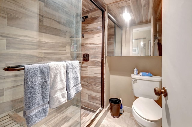 bathroom with toilet and a shower with door