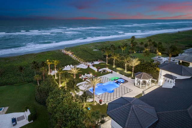 aerial view at dusk with a water view