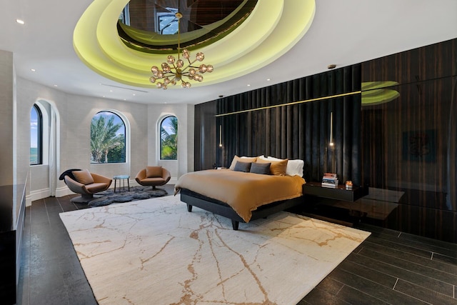 bedroom featuring dark hardwood / wood-style flooring and a tray ceiling