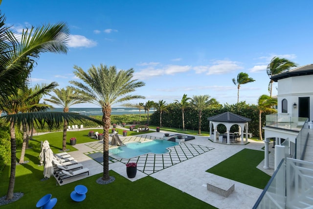 view of swimming pool featuring a gazebo, a water view, a yard, and a patio