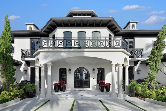 exterior space featuring a balcony and french doors