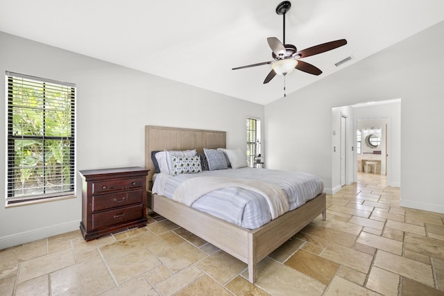 bedroom featuring multiple windows, ceiling fan, ensuite bathroom, and lofted ceiling