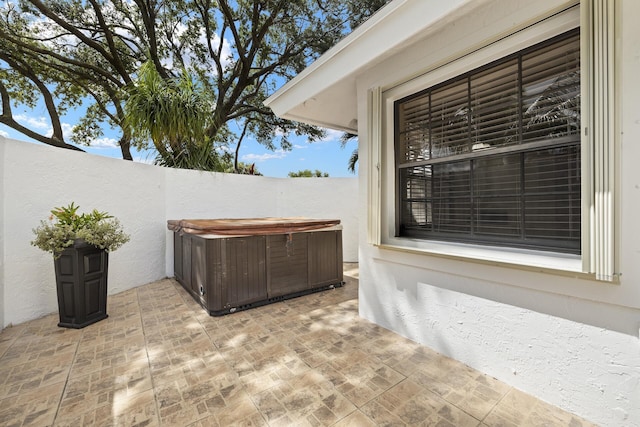 view of patio / terrace featuring a hot tub