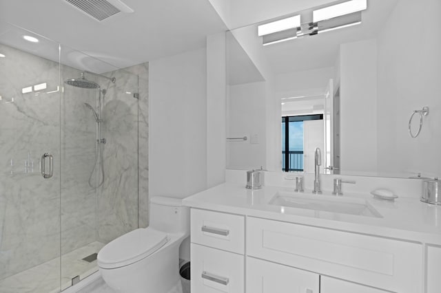 bathroom with a shower with shower door, toilet, and vanity