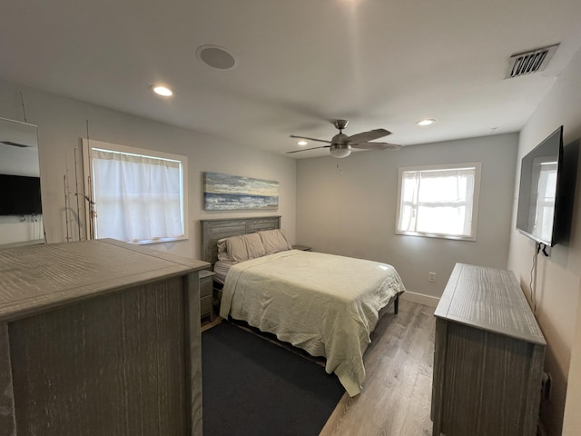 bedroom with ceiling fan and hardwood / wood-style flooring