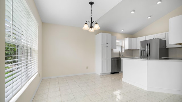 kitchen with white cabinetry, stainless steel appliances, decorative light fixtures, lofted ceiling, and a chandelier