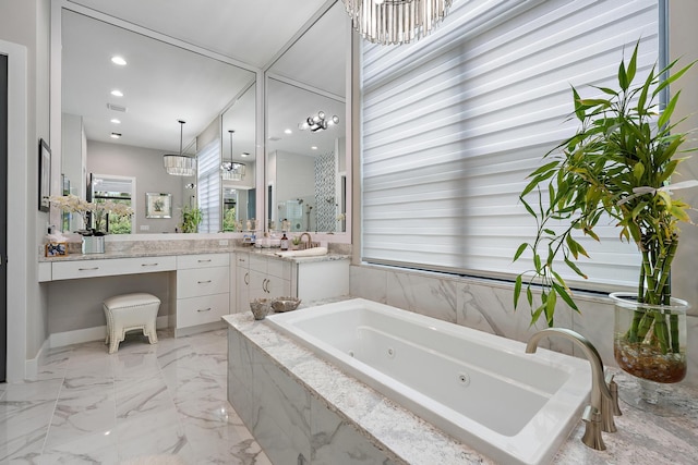 bathroom featuring vanity, tile patterned floors, and tiled bath