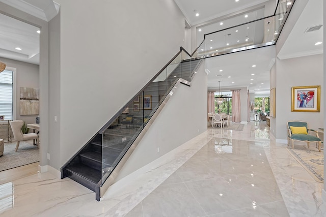 staircase with visible vents, baseboards, marble finish floor, and ornamental molding