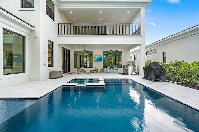 view of pool with grilling area, a patio, a pool with connected hot tub, and a ceiling fan