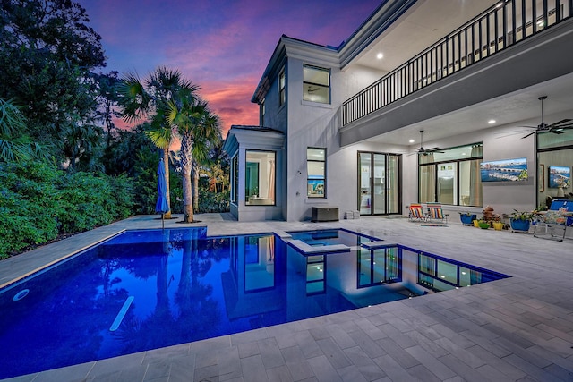 view of swimming pool featuring a patio and ceiling fan