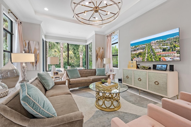 living room with ornamental molding, a raised ceiling, and a chandelier