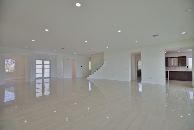 unfurnished living room featuring light tile patterned floors