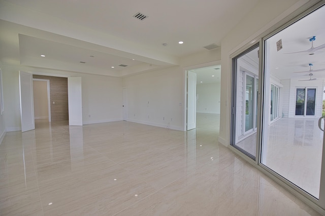 empty room featuring ceiling fan and light tile patterned floors