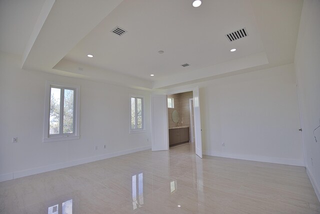 13064 Via Flavia, Placida, FL 33946 - unfurnished room with a raised ceiling, baseboards, and recessed lighting