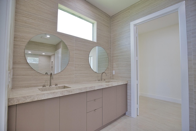 bathroom featuring tile walls, dual vanity, and tile patterned floors