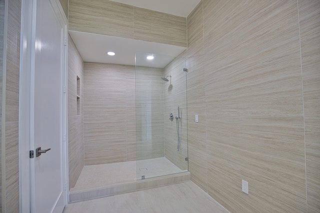 bathroom featuring tile patterned floors and a shower with shower door