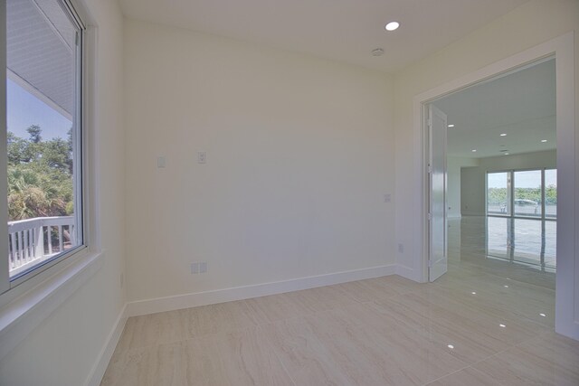 spare room featuring light tile patterned floors