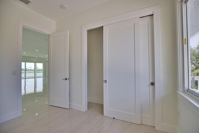 13064 Via Flavia, Placida, FL 33946 - unfurnished bedroom featuring a closet, baseboards, and a water view