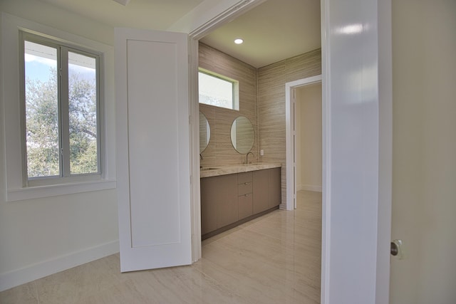 bathroom with a healthy amount of sunlight, vanity, and tile patterned floors