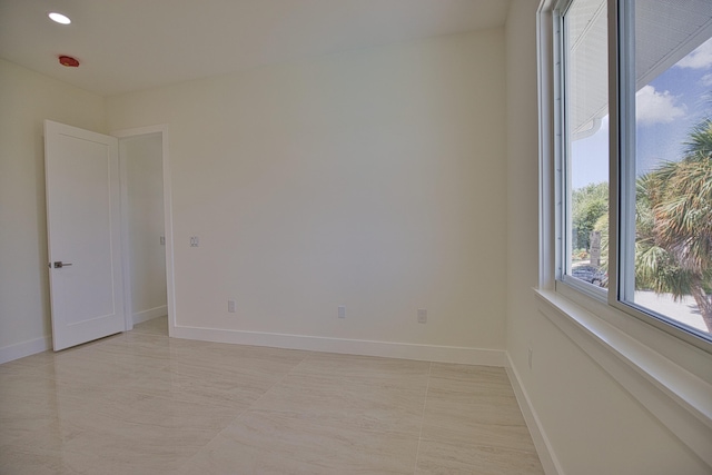 unfurnished room with light tile patterned floors