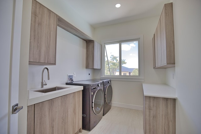 clothes washing area with sink, cabinets, separate washer and dryer, and light tile patterned flooring