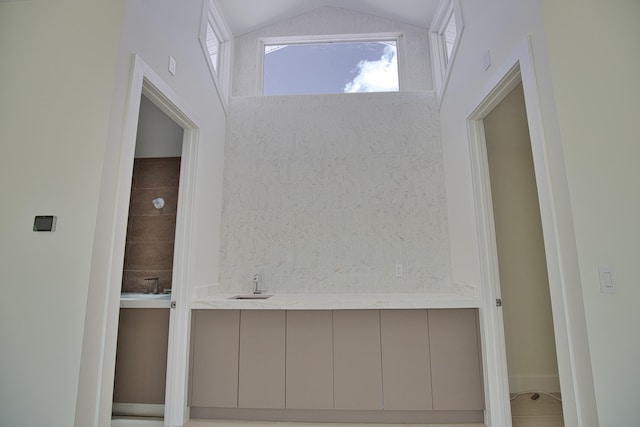 interior space with sink, lofted ceiling, and a healthy amount of sunlight