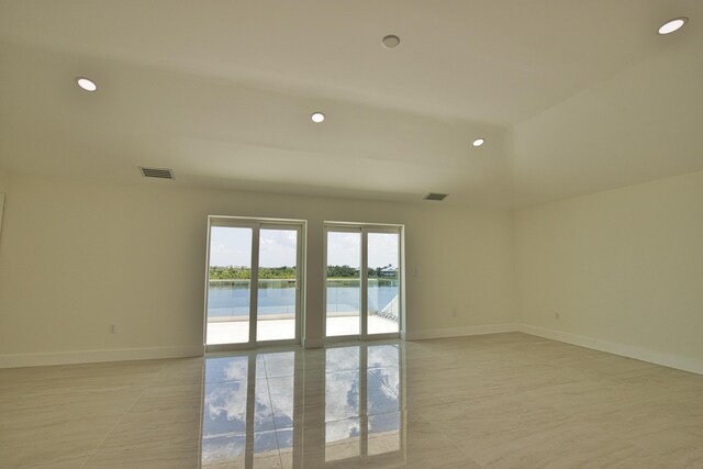 13064 Via Flavia, Placida, FL 33946 - unfurnished room featuring a water view, baseboards, and recessed lighting