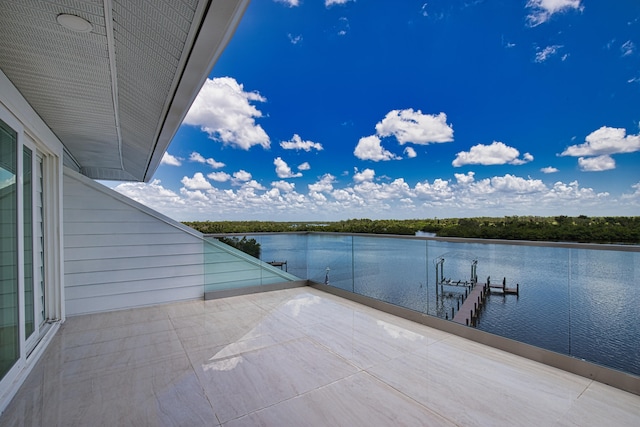 exterior space featuring a balcony and a water view