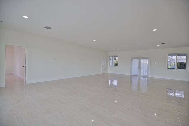 13064 Via Flavia, Placida, FL 33946 - spare room with light tile patterned flooring, plenty of natural light, recessed lighting, and baseboards