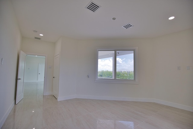 unfurnished room featuring light tile patterned floors