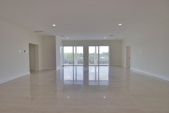 spare room featuring light tile patterned flooring