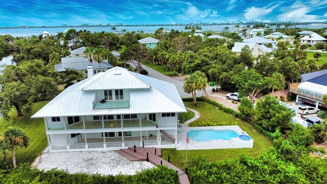 13064 Via Flavia, Placida, FL 33946 - rear view of house featuring an outdoor pool, metal roof, a patio area, and a water view