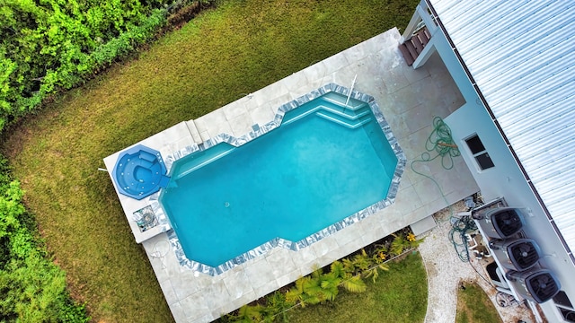 view of swimming pool featuring washer / dryer, a patio, and a yard