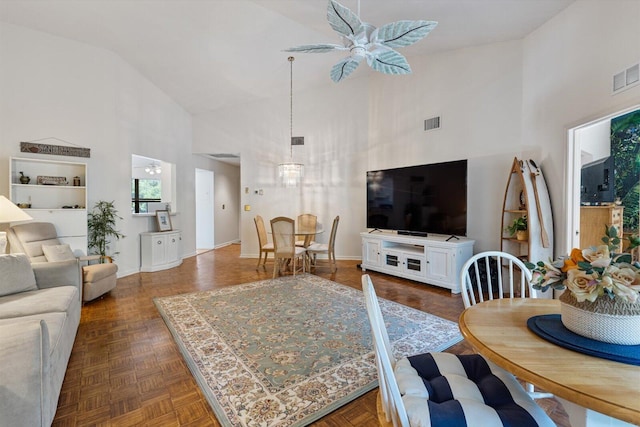 living room featuring ceiling fan, dark parquet flooring, and high vaulted ceiling