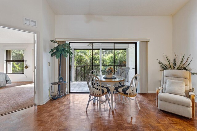 dining area with parquet flooring