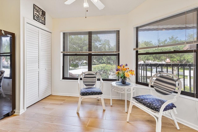 sunroom / solarium featuring ceiling fan