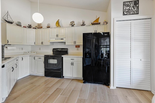 kitchen with white cabinetry, decorative light fixtures, vaulted ceiling, and black appliances