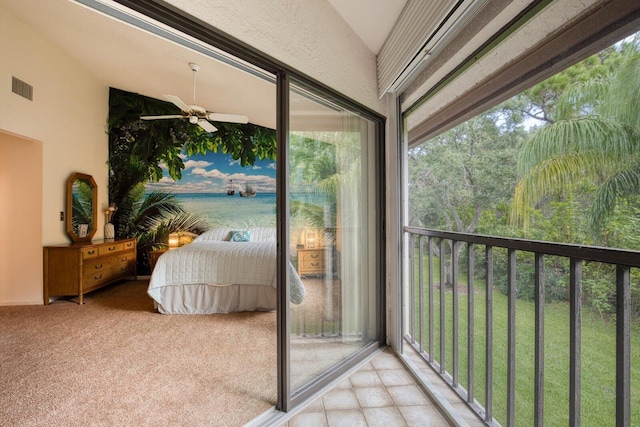 sunroom with lofted ceiling and ceiling fan