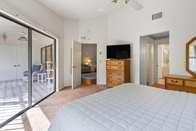 bedroom with light colored carpet, a closet, ceiling fan, access to exterior, and a high ceiling