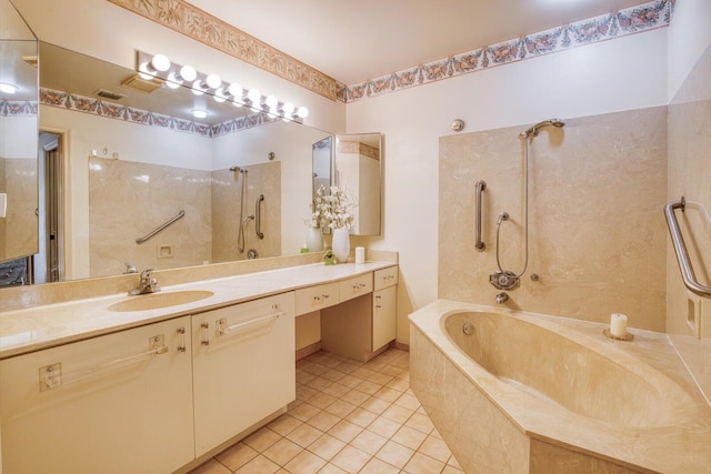 bathroom featuring vanity, tile patterned flooring, and tiled shower / bath