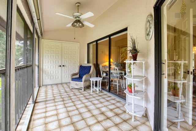 sunroom / solarium featuring ceiling fan and vaulted ceiling