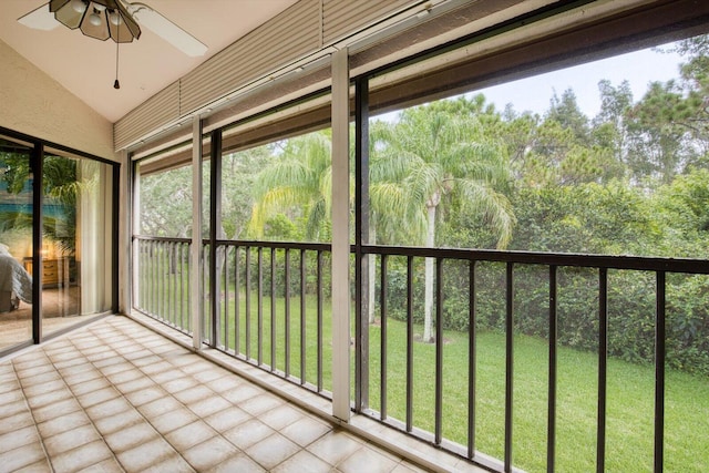 unfurnished sunroom with vaulted ceiling and ceiling fan