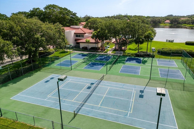 view of tennis court featuring a water view