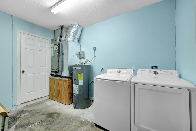 laundry area with water heater, washing machine and clothes dryer, and a textured ceiling