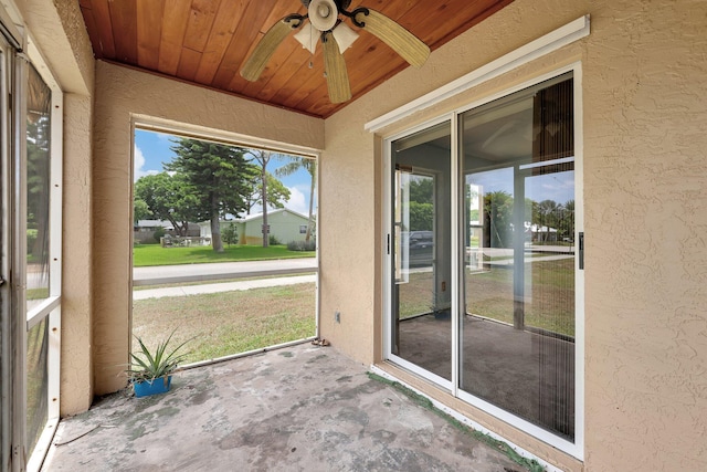 unfurnished sunroom with ceiling fan and wood ceiling