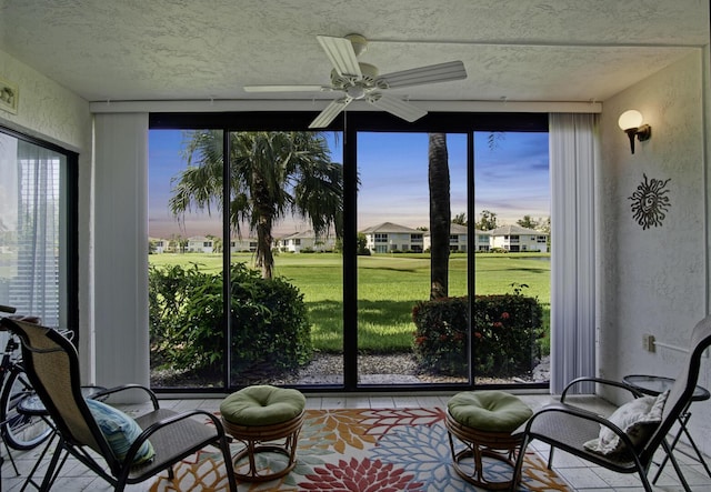 sunroom / solarium with a wealth of natural light and ceiling fan