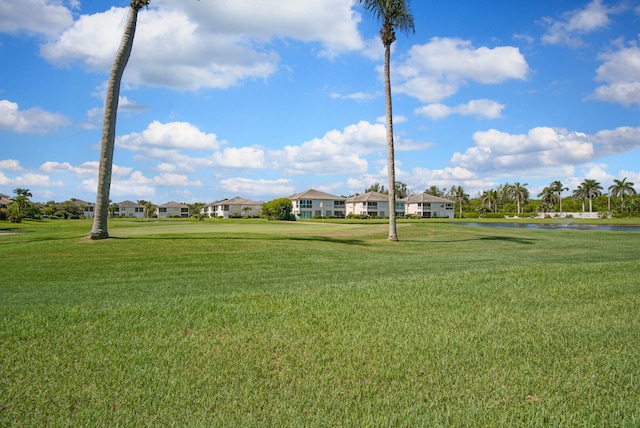 surrounding community featuring a lawn and a water view